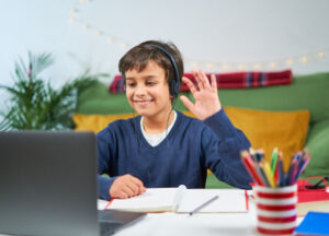A child participates in handwriting, phonics, and spoken English lessons in online classes for kids